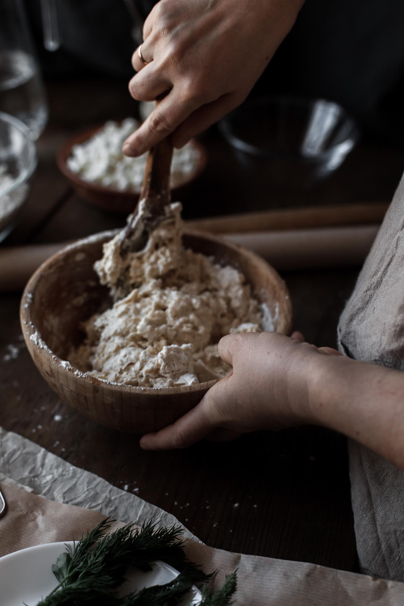 hands preparing dough in rustic kitchen